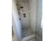 Updated bathroom features a shower with gray tile surround and mosaic tile floor at 5517 Bowerman Way, Las Vegas, NV 89130