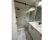 Contemporary bathroom features a glass enclosed shower with stone floor and updated vanity at 5517 Bowerman Way, Las Vegas, NV 89130
