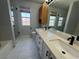 Bright bathroom features a double sink vanity, shower and window letting in lots of light at 5517 Bowerman Way, Las Vegas, NV 89130