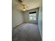 Comfortable bedroom featuring a window providing natural light and neutral carpet at 5517 Bowerman Way, Las Vegas, NV 89130