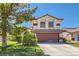 Charming two-story home with a well-manicured lawn and mature trees on a sunny day at 5517 Bowerman Way, Las Vegas, NV 89130