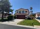 Inviting two-story home featuring a red tile roof, two-car garage, and freshly cut lawn at 5517 Bowerman Way, Las Vegas, NV 89130