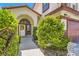 Landscaped walkway leads to a welcoming front door with an arched transom window at 5517 Bowerman Way, Las Vegas, NV 89130