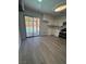 Charming kitchen with white cabinets, sleek appliances, and adjacent view of backyard pool at 5517 Bowerman Way, Las Vegas, NV 89130