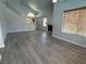 Sunlit living room with fireplace, staircase, and stylish gray flooring at 5517 Bowerman Way, Las Vegas, NV 89130