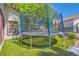 Backyard featuring a trampoline on artificial grass, perfect for Gathering fun at 5517 Bowerman Way, Las Vegas, NV 89130