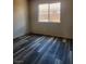A bright bedroom featuring wood-look flooring and a sunny window offering natural light at 5536 Cleary Ct, Las Vegas, NV 89108