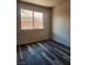 A simple bedroom featuring wood-look flooring and a sunny window offering natural light at 5536 Cleary Ct, Las Vegas, NV 89108