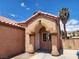 Charming facade featuring stucco columns, a terracotta tile roof, security door, and an arched entryway at 5536 Cleary Ct, Las Vegas, NV 89108