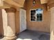 Inviting front porch showcasing decorative pillars, stucco walls, a white security door, and a window at 5536 Cleary Ct, Las Vegas, NV 89108