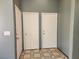 Hallway view highlighting three white doors and neutral tiled floors in a home's interior at 5536 Cleary Ct, Las Vegas, NV 89108