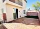 Backyard with wooden patio, artificial grass area and upstairs balcony at 5634 Bishop Flowers St, Las Vegas, NV 89130