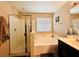 This bathroom showcases a soaking tub, glass-enclosed shower, and neutral finishes at 5634 Bishop Flowers St, Las Vegas, NV 89130