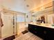 Elegant bathroom featuring double vanity, soaking tub, and glass-enclosed shower at 5634 Bishop Flowers St, Las Vegas, NV 89130