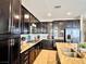 Kitchen featuring dark cabinets, granite countertops, stainless steel appliances and tiled floors at 5634 Bishop Flowers St, Las Vegas, NV 89130