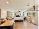 Open living room with granite countertops, hanging lights, and tile flooring at 5634 Bishop Flowers St, Las Vegas, NV 89130