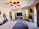 Spacious main bedroom with ceiling fan, television, and exercise equipment at 5634 Bishop Flowers St, Las Vegas, NV 89130