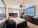 Main bedroom featuring a ceiling fan, large television, and dresser at 5634 Bishop Flowers St, Las Vegas, NV 89130
