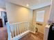 Carpeted staircase with white railing, leading to the upper level of this beautiful home at 5634 Bishop Flowers St, Las Vegas, NV 89130
