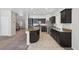 Stylish kitchen with dark cabinets, granite countertops, and an island with seating at 5655 Danforth Ave, Las Vegas, NV 89141