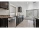 Kitchen featuring stainless steel dishwasher, dark cabinets, and granite counters at 5655 Danforth Ave, Las Vegas, NV 89141