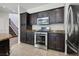 Kitchen featuring stainless appliances, dark cabinetry, and granite countertops at 5655 Danforth Ave, Las Vegas, NV 89141
