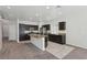 Modern kitchen with stainless steel appliances, dark wood cabinets, and a center island at 5655 Danforth Ave, Las Vegas, NV 89141