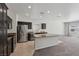 Open kitchen features stainless steel appliances, granite countertops, and a large island with seating at 5655 Danforth Ave, Las Vegas, NV 89141