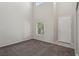 Bright room featuring neutral carpet, high ceilings, and a large window with views of the yard at 5655 Danforth Ave, Las Vegas, NV 89141
