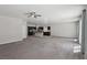 Spacious open-concept living area showcasing neutral carpet and a modern ceiling fan at 5655 Danforth Ave, Las Vegas, NV 89141