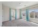 Large main bedroom with neutral carpet and curtains with access to the main bathroom at 5655 Danforth Ave, Las Vegas, NV 89141