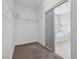 Walk-in closet with wire shelving, carpet flooring, and bathroom entrance at 5655 Danforth Ave, Las Vegas, NV 89141