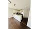 Bright kitchen with white cabinets, stainless steel appliances, and dark wood flooring at 5711 Roundrock Dr, Las Vegas, NV 89142
