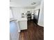 Bright kitchen featuring stainless steel appliances, an eat-in island and white cabinets with modern hardware at 5711 Roundrock Dr, Las Vegas, NV 89142