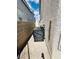 Narrow side yard with a covered grill between the house and a brick wall at 5711 Roundrock Dr, Las Vegas, NV 89142