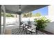Backyard patio featuring an outdoor patio set, mature landscaping, and partial view of the pool at 5929 Royal Castle Ln, Las Vegas, NV 89130
