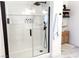 Modern shower with glass enclosure, a handheld shower head, and wall shelving at 5929 Royal Castle Ln, Las Vegas, NV 89130