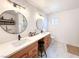 Bright bathroom features a double sink vanity, dual mirrors, and elegant fixtures at 5929 Royal Castle Ln, Las Vegas, NV 89130