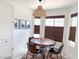 Cozy dining area with a round wooden table, leather chairs, and a unique woven pendant light at 5929 Royal Castle Ln, Las Vegas, NV 89130