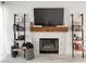 Stylish fireplace featuring white tile surround, rustic mantel, and decorative shelving for a modern look at 5929 Royal Castle Ln, Las Vegas, NV 89130