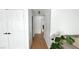 Bright hallway featuring hardwood flooring, white doors, and neutral walls at 5929 Royal Castle Ln, Las Vegas, NV 89130