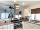 Well-lit kitchen featuring stainless steel appliances, granite countertops, and white cabinetry providing ample space at 5929 Royal Castle Ln, Las Vegas, NV 89130