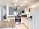 Modern kitchen with stainless steel appliances, granite countertops, and white cabinetry offering ample storage at 5929 Royal Castle Ln, Las Vegas, NV 89130