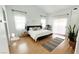 Main bedroom featuring a bed, hardwood floors, and lots of natural light at 5929 Royal Castle Ln, Las Vegas, NV 89130