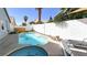 Backyard featuring a sparkling pool and spa, enhanced by a patio and lush landscaping at 5929 Royal Castle Ln, Las Vegas, NV 89130