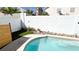 View of the pool showing its perimeter, with the white brick wall and artificial turf at 5929 Royal Castle Ln, Las Vegas, NV 89130