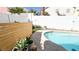 Backyard pool with artificial turf and a white brick wall creating a private outdoor oasis at 5929 Royal Castle Ln, Las Vegas, NV 89130