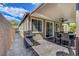 View of backyard with covered patio area with a grill and dining table at 5957 Olivine Falls Ave, Las Vegas, NV 89130