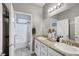 Bright bathroom featuring dual sinks, granite countertops, and a tub-shower combo at 5957 Olivine Falls Ave, Las Vegas, NV 89130