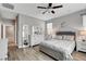 This bedroom has a ceiling fan, wood floors, and a bedroom set at 5957 Olivine Falls Ave, Las Vegas, NV 89130